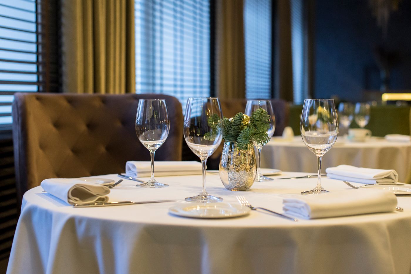 A small table with chairs and clear place settings