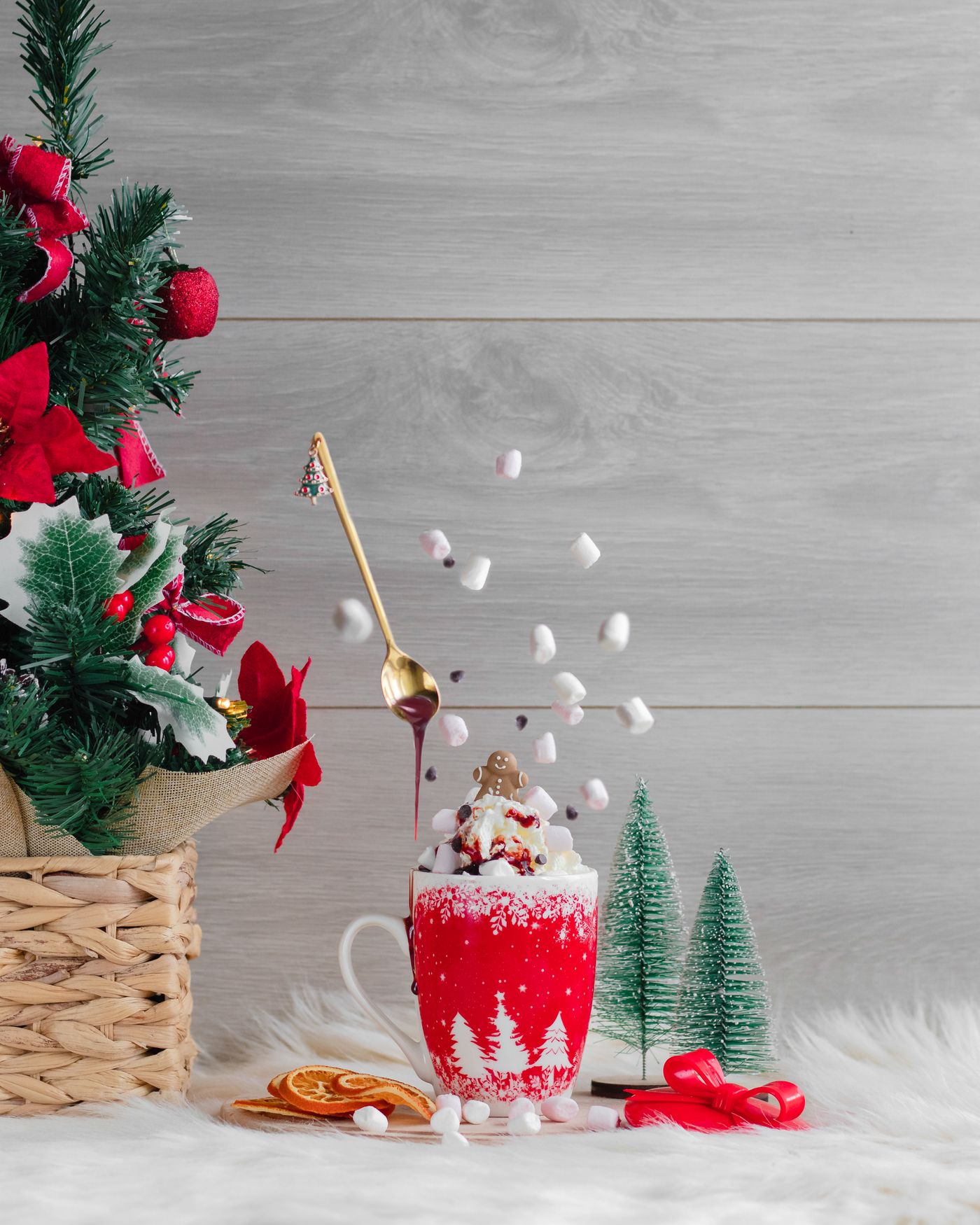 A mug of hot chocolate placed beside Christmas decorations