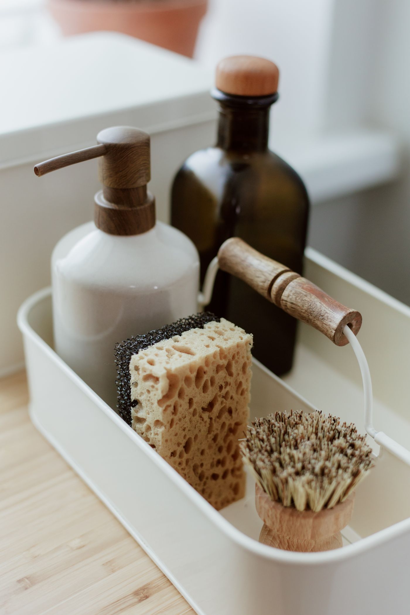 Soap bottles and brushes grouped in a household tray