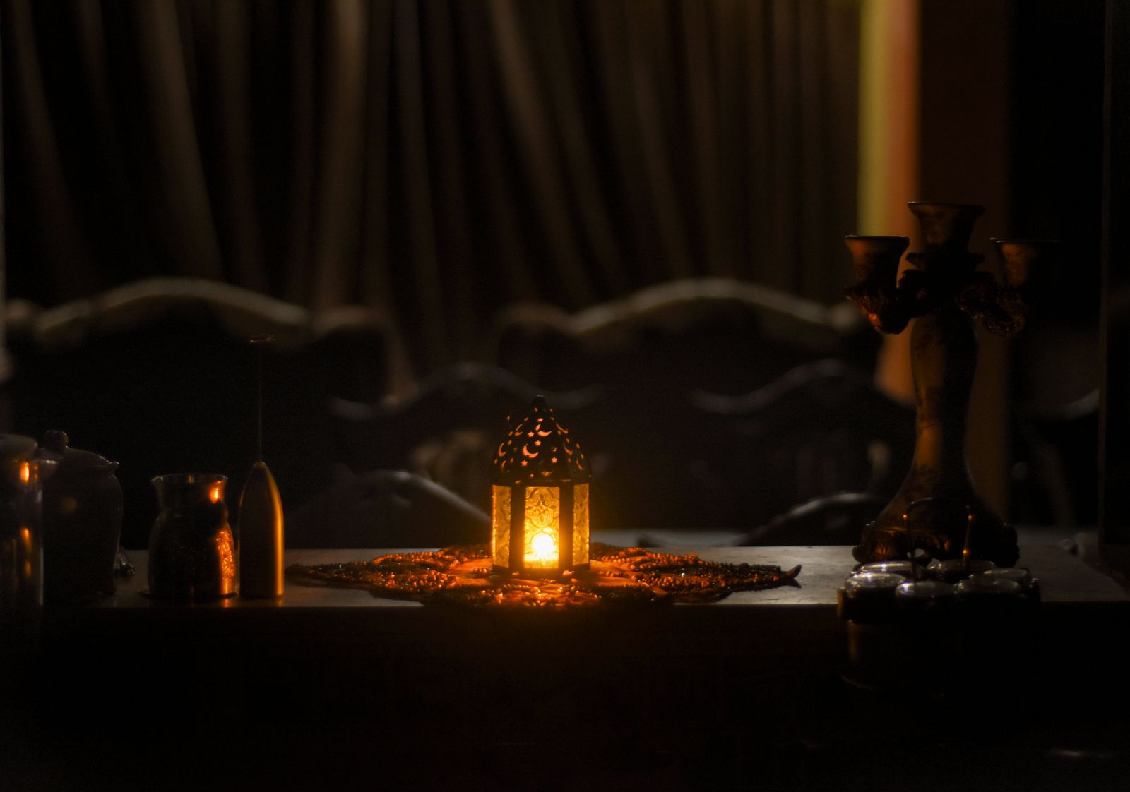 A glowing lantern on a decorated table