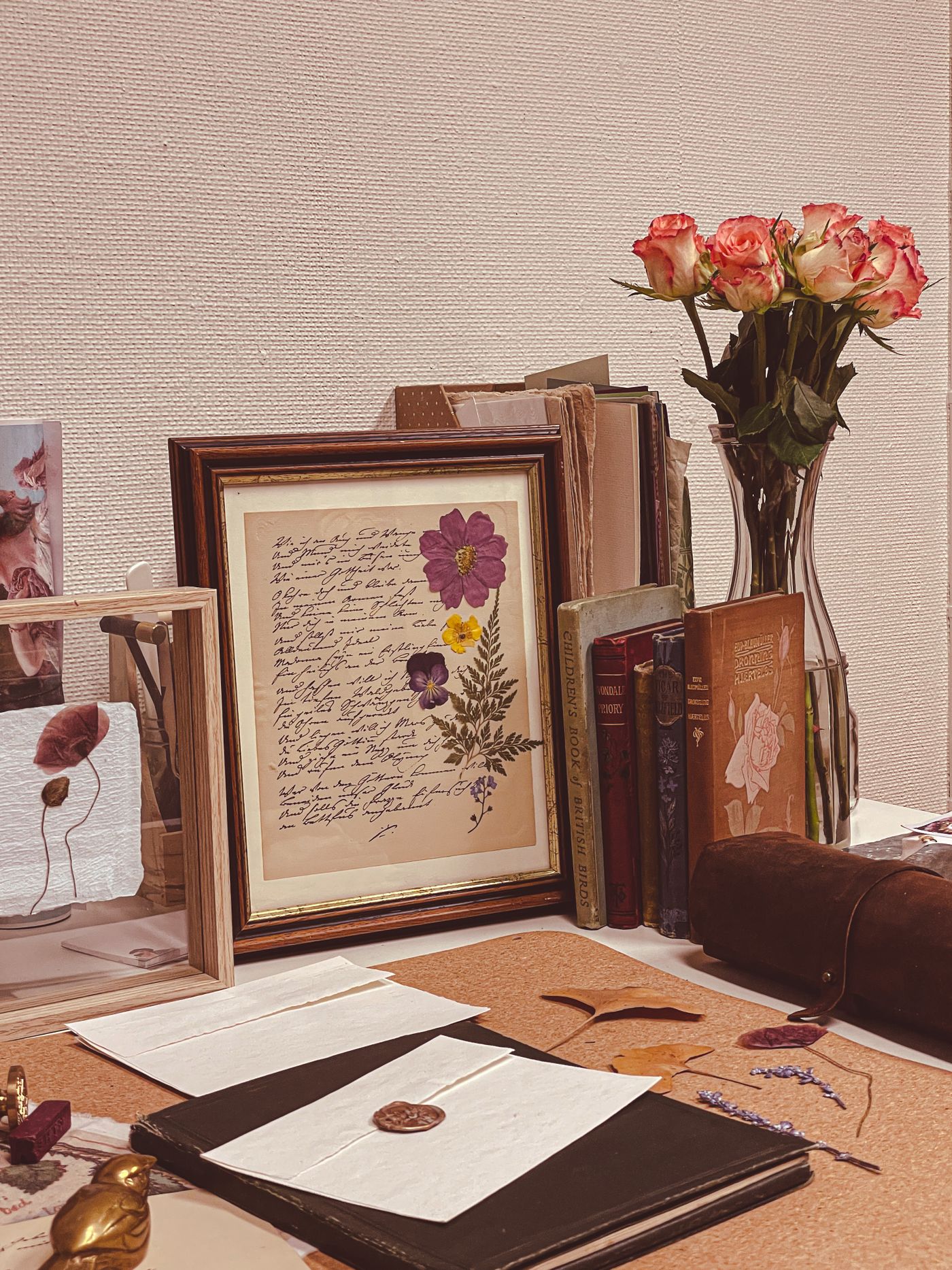 Writing desk with framed correspondence and paper keepsakes