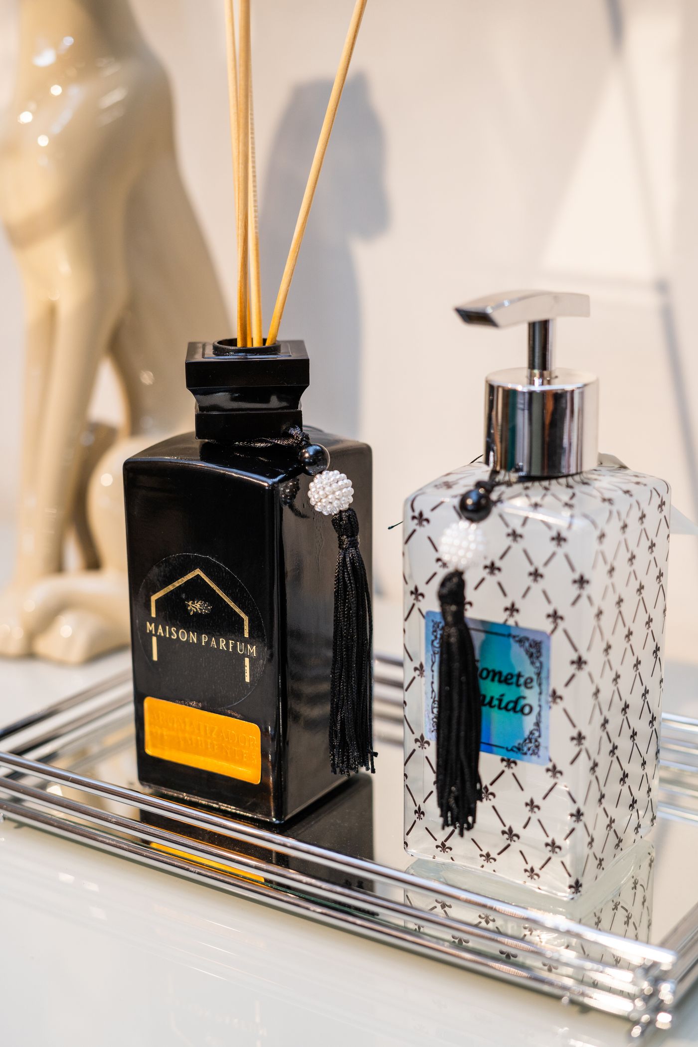 A patterned pump dispenser beside another decorative container