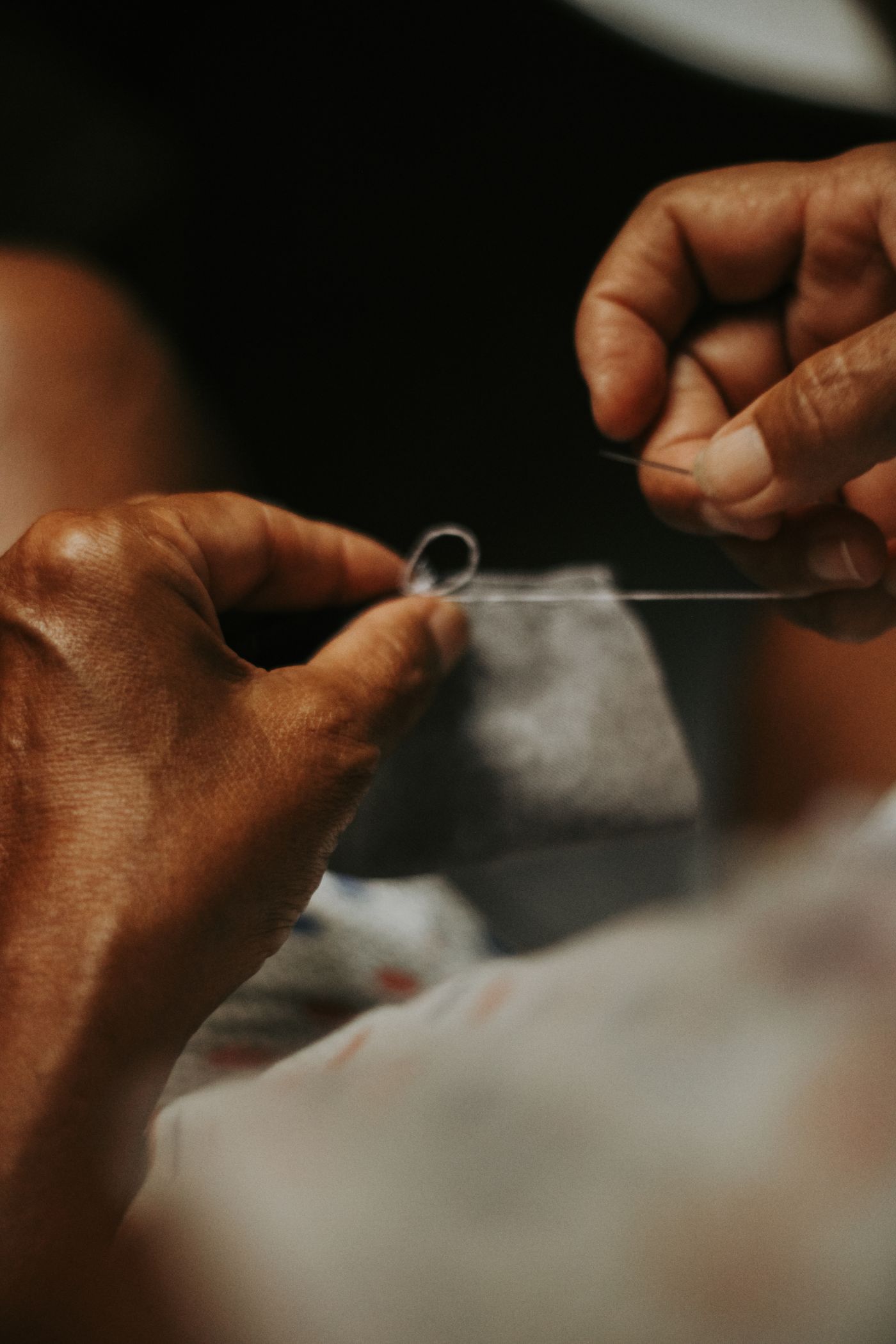 Hands stitching a small section of fabric