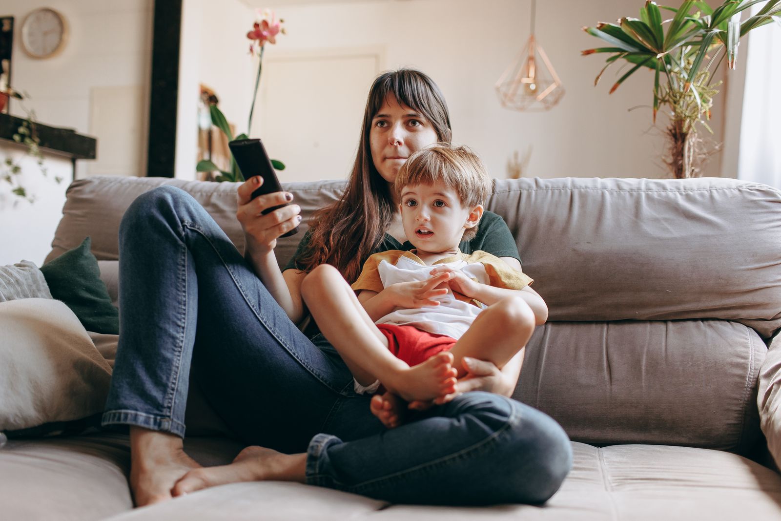 An adult and child seated together during television viewing