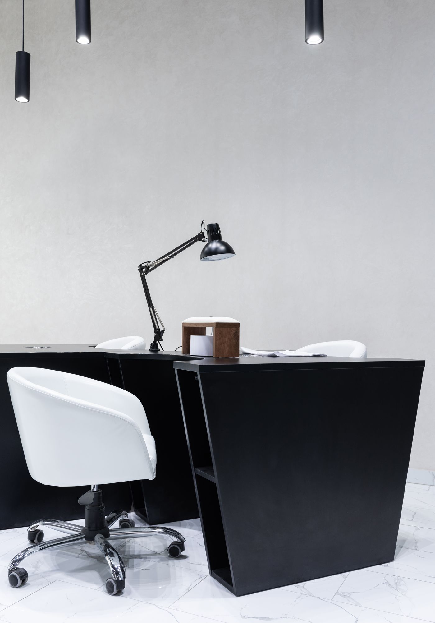 A simple desk with a chair, lamp, and room around the work surface