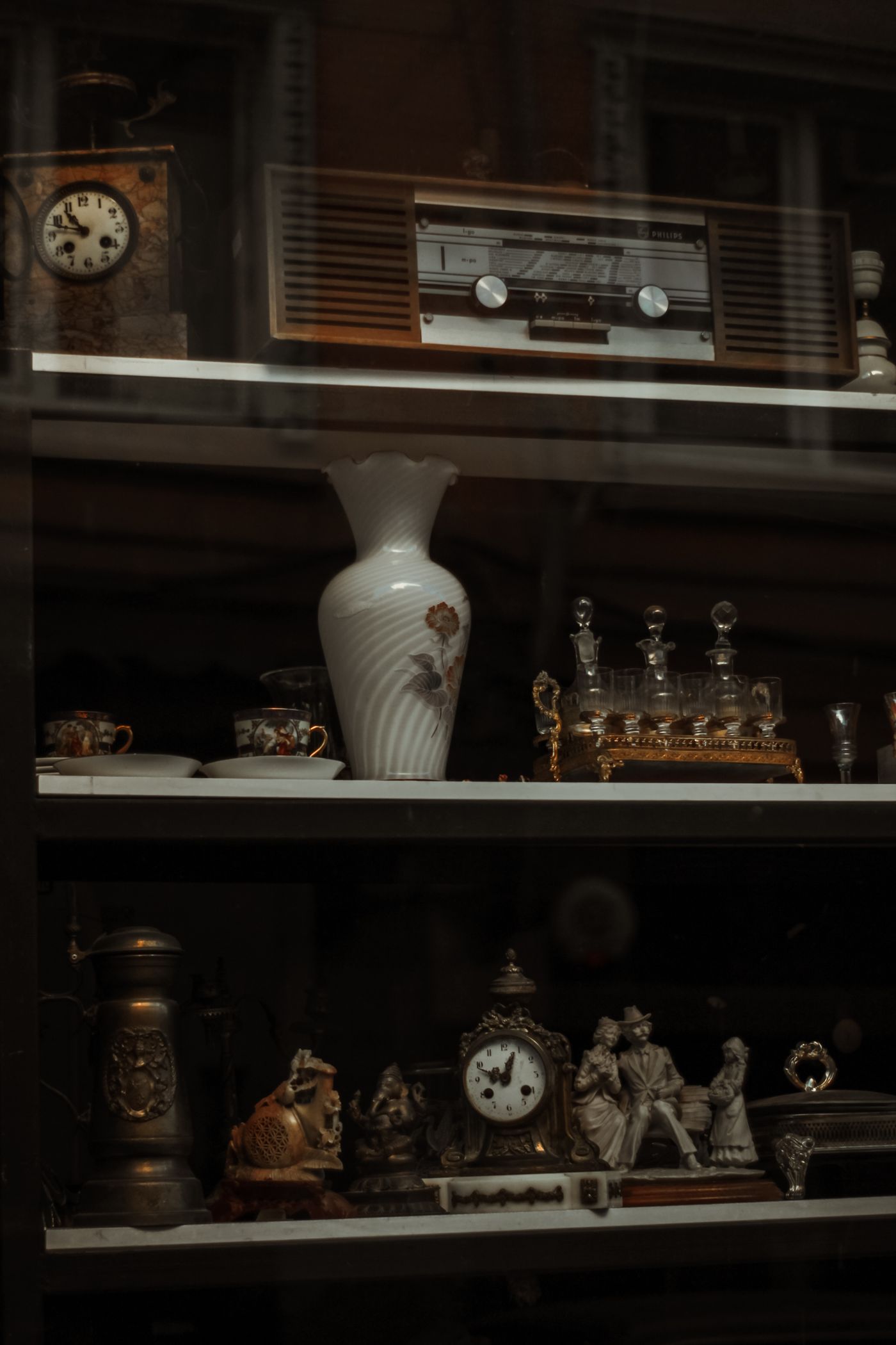 Vintage objects arranged inside a display cabinet
