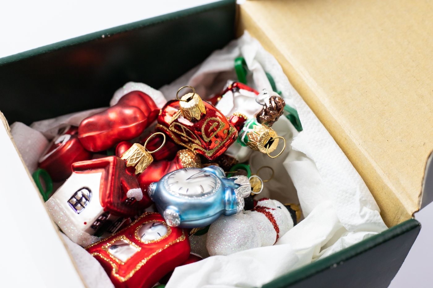 Mixed ornaments resting inside a lined cardboard box