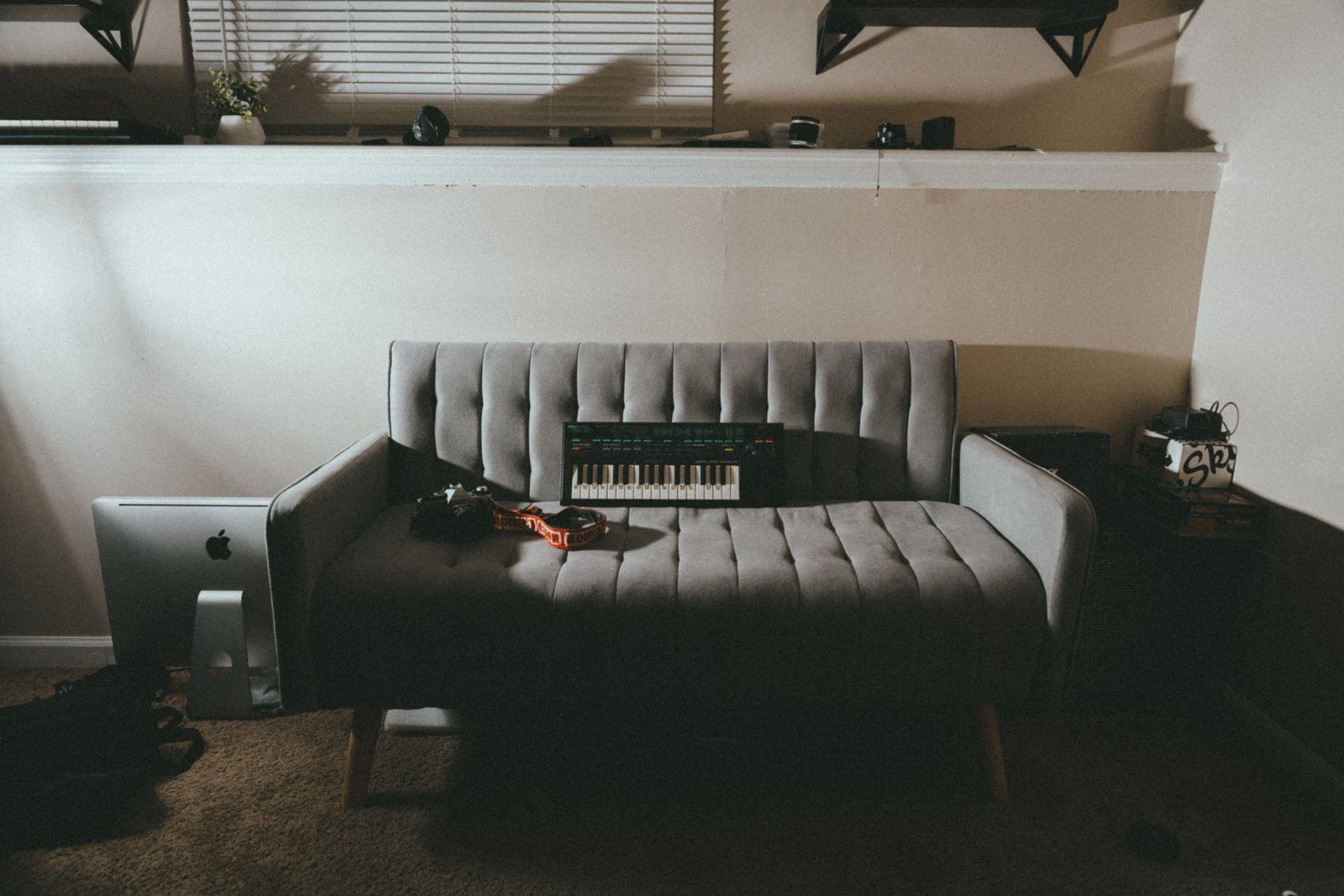 A keyboard placed temporarily on a sofa seat