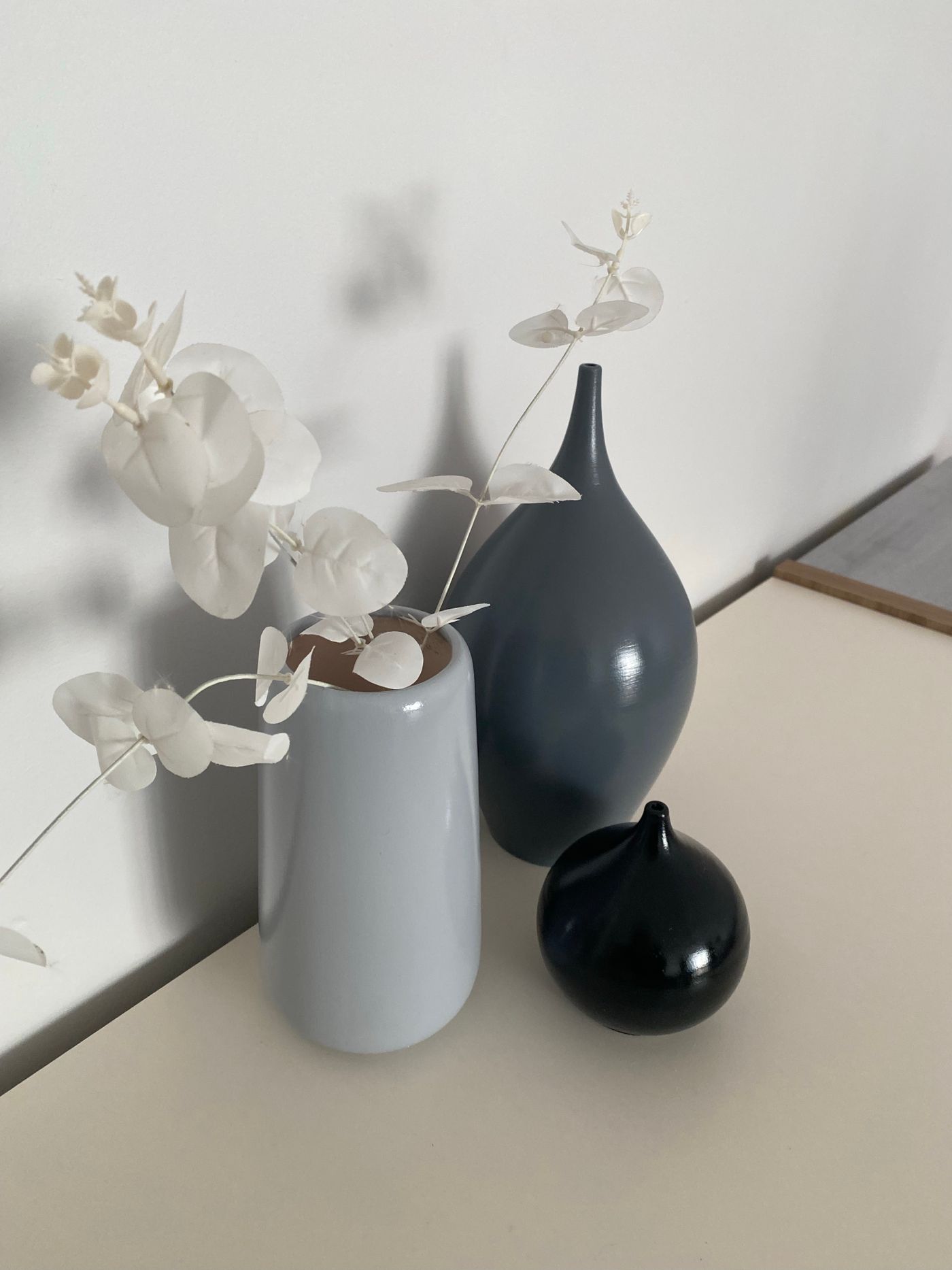 Several decorative vases grouped on a household surface