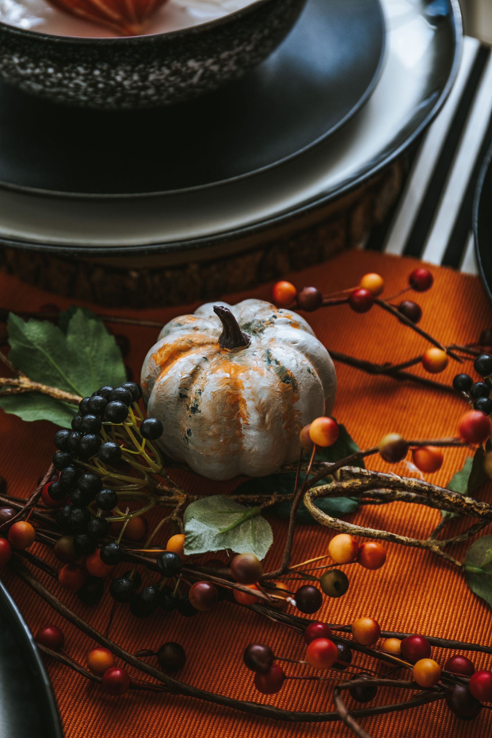 A pumpkin centerpiece on an autumn dining table
