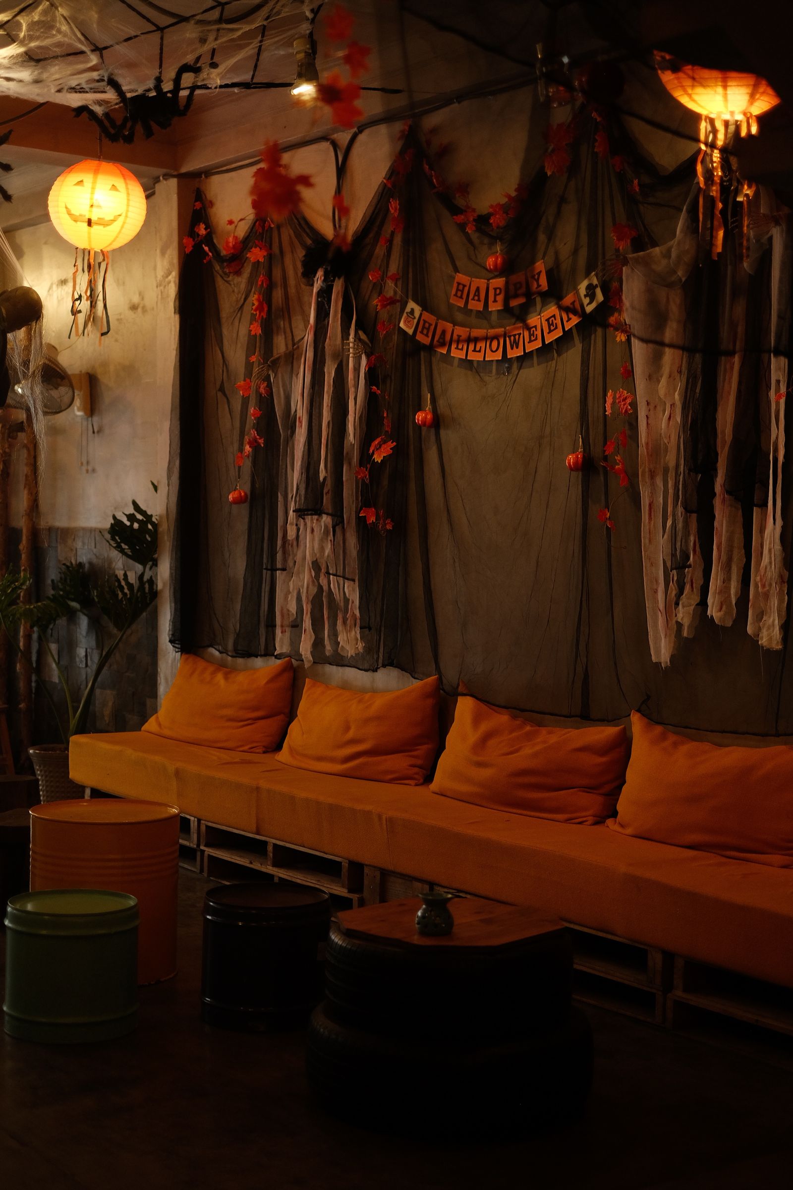 Halloween-themed interior with a bench and orange cushions