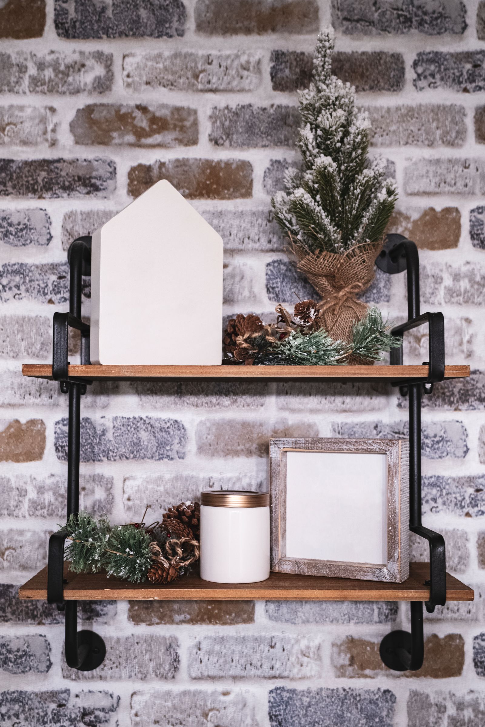 Small Christmas decorations arranged on wooden shelves