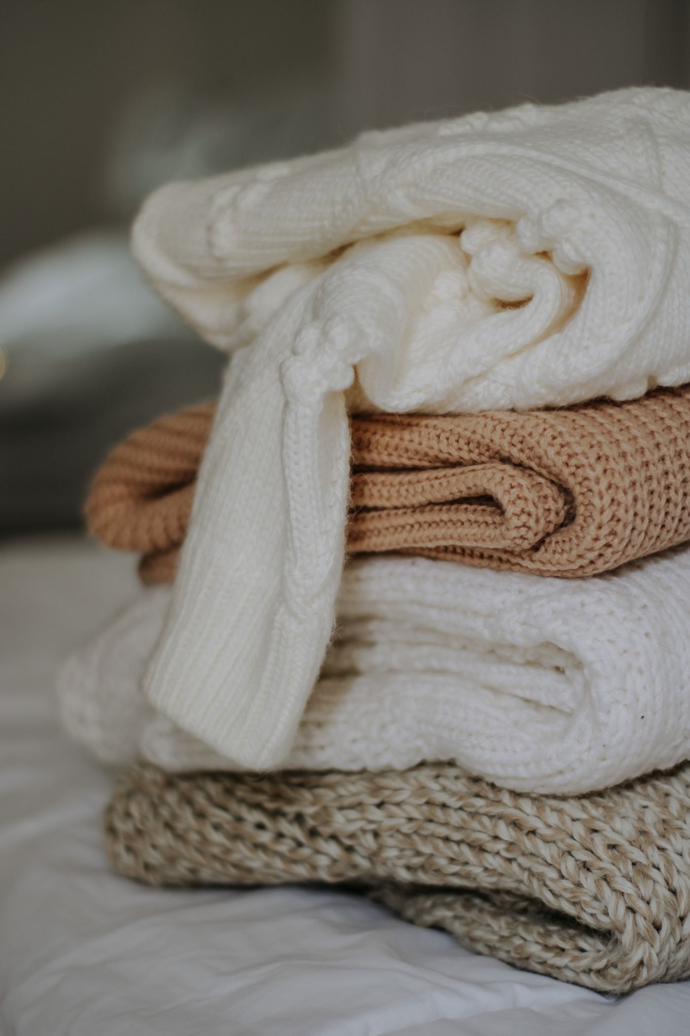 Folded cream and beige knitted textiles stacked together