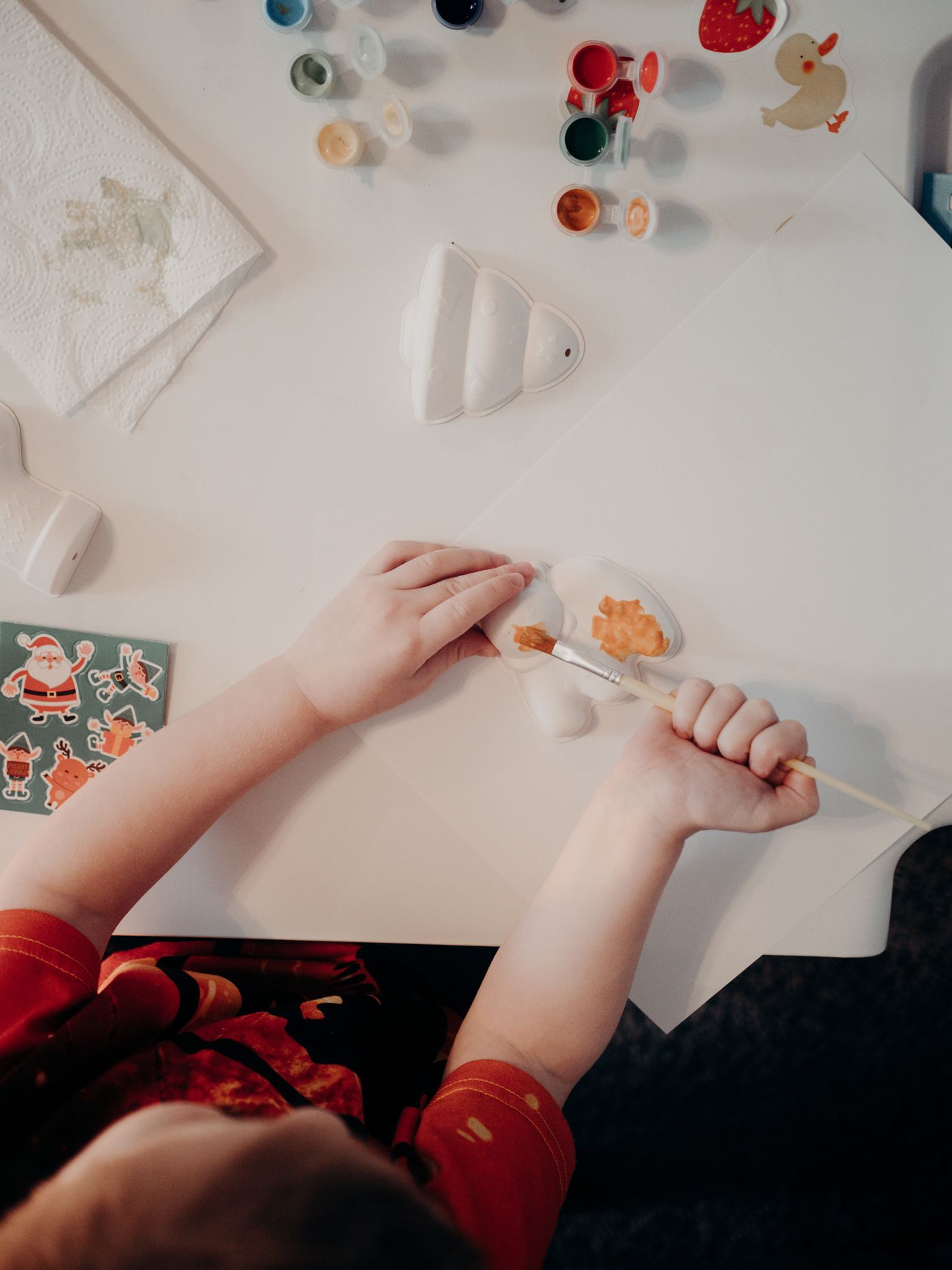 A child painting in an individual work area