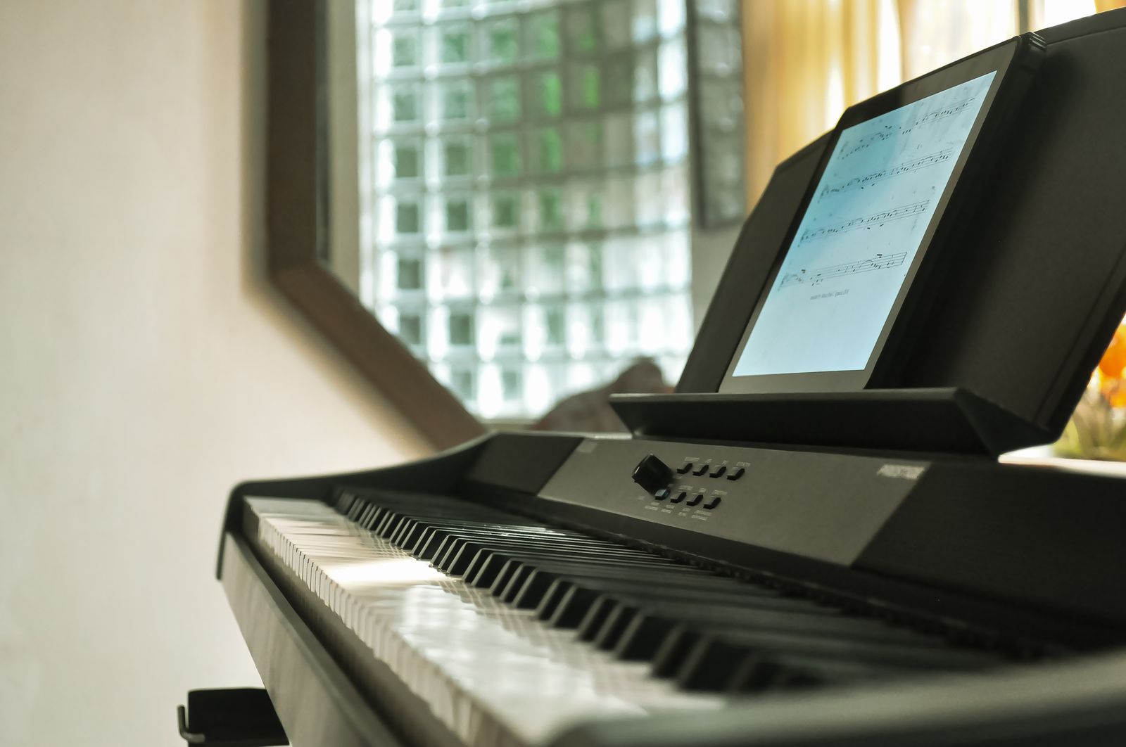 Digital keyboard keys beneath an electronic music display