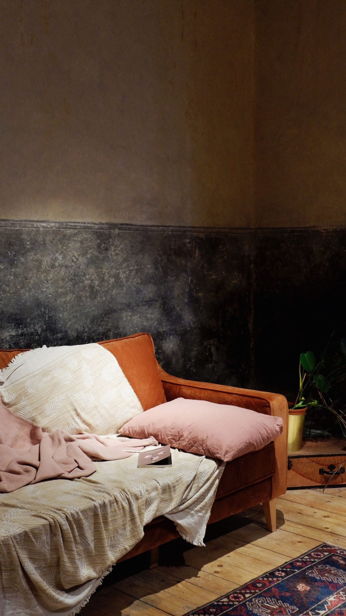 Blankets and a pillow arranged on an ordinary sofa