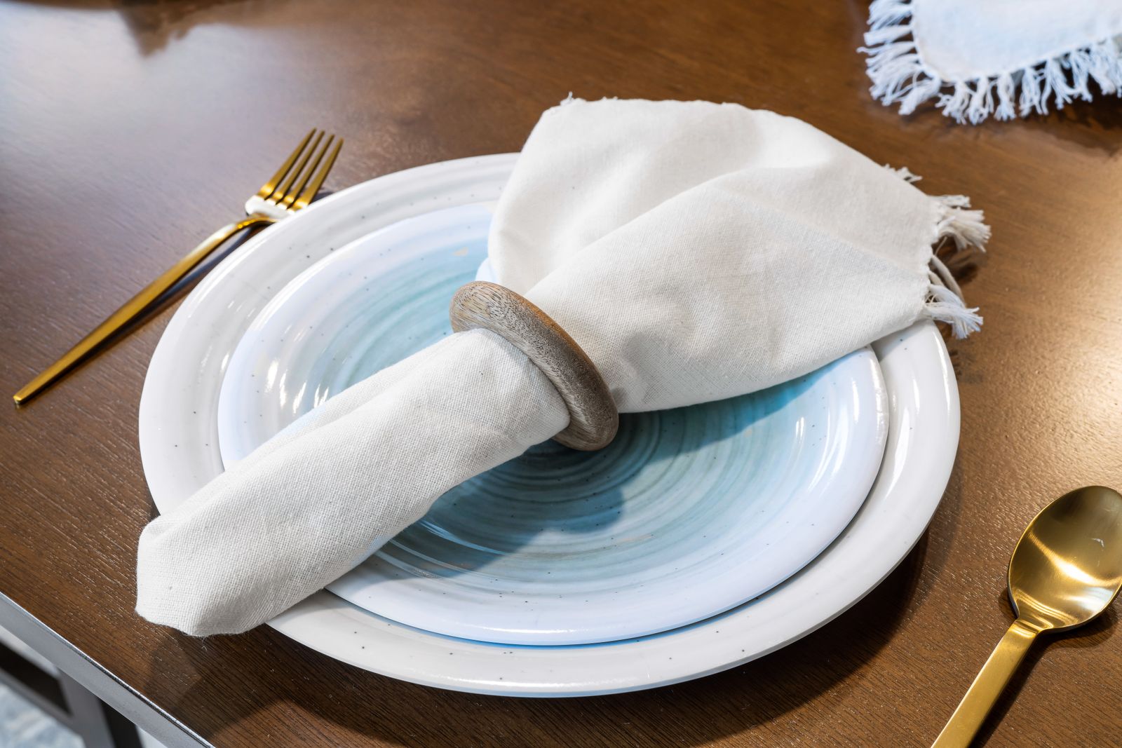 A linen napkin tied over stacked plates