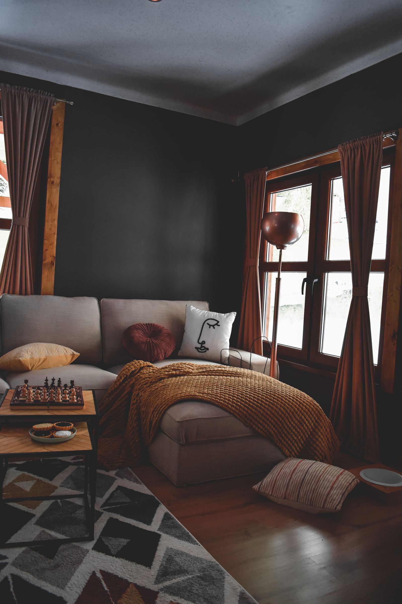 Beige sofa with cushions beside a wooden table