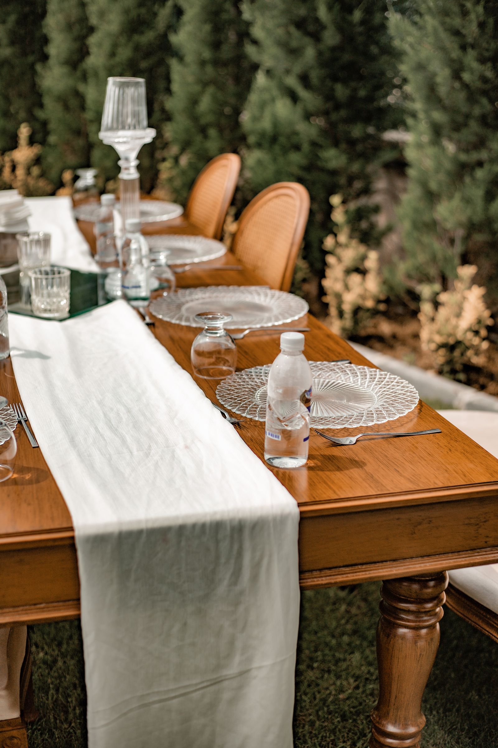 A long pale runner across an outdoor dining table