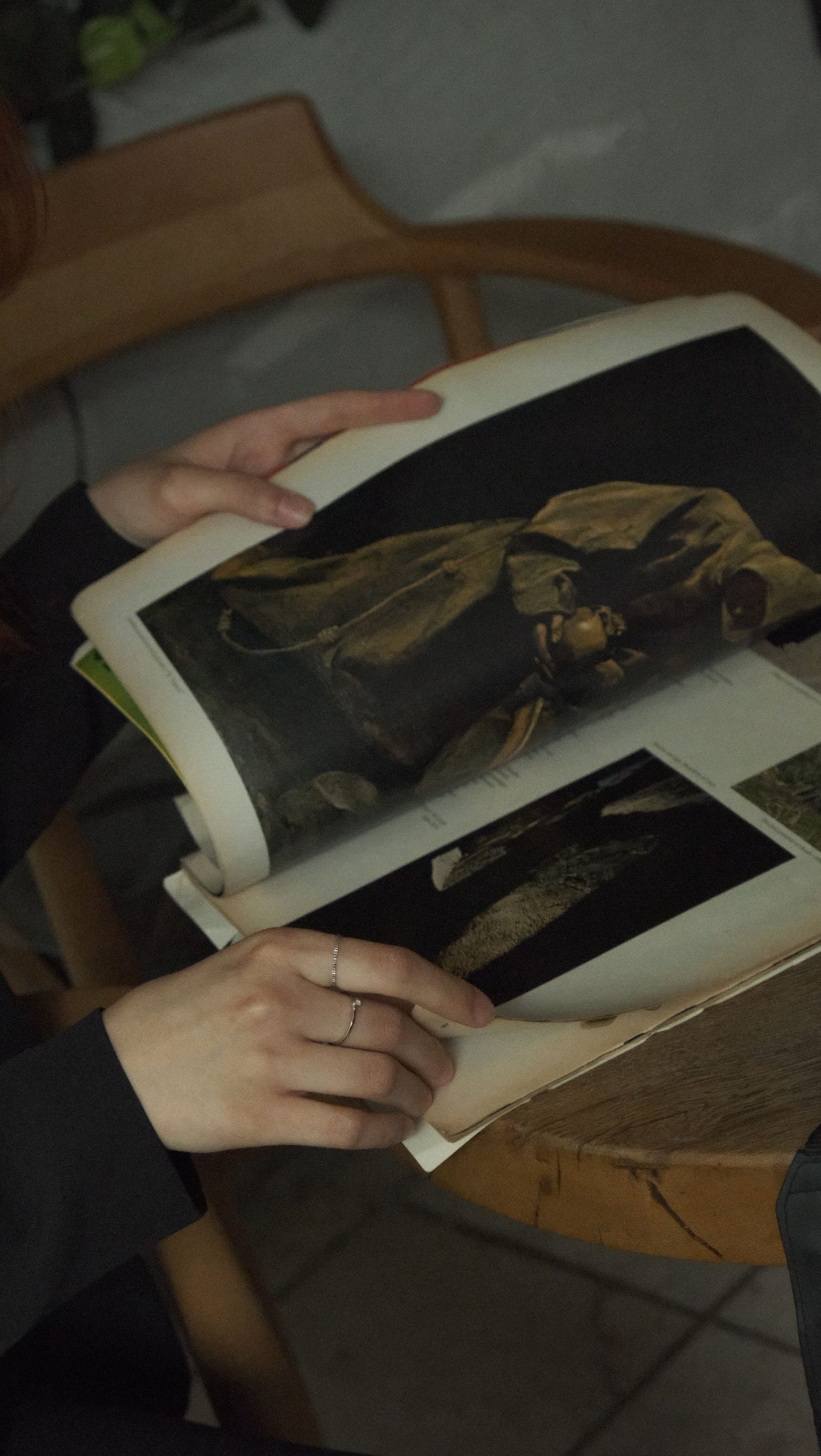 A person holding an album with old photographs
