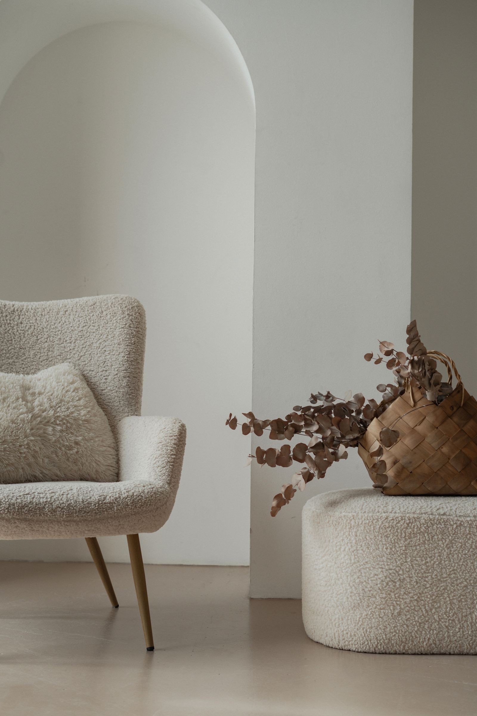 Neutral armchair with autumn-colored decorative foliage
