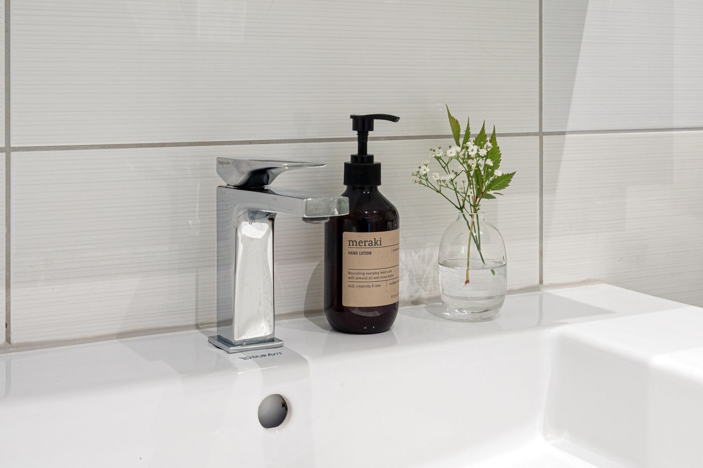 Pump dispensers arranged on a bathroom basin ledge