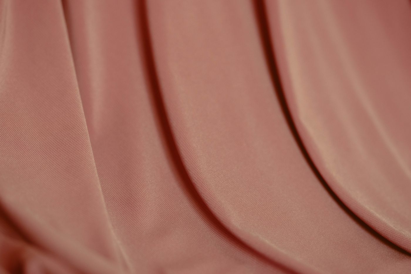 Pink textile folds showing a rich fabric texture