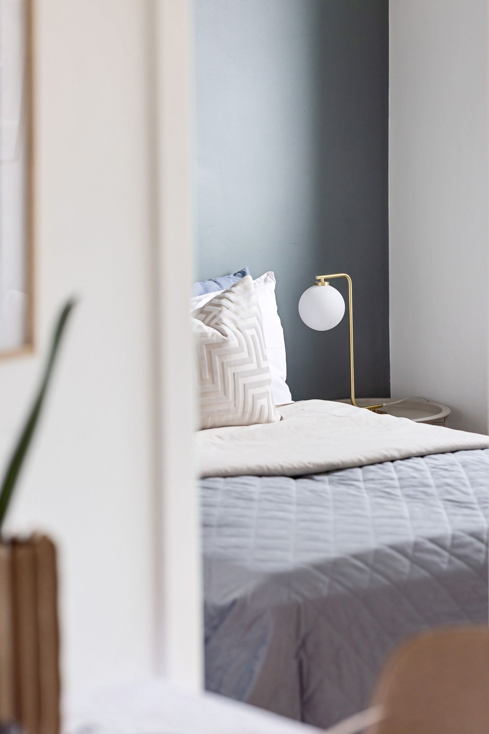 An open doorway leading toward a bed
