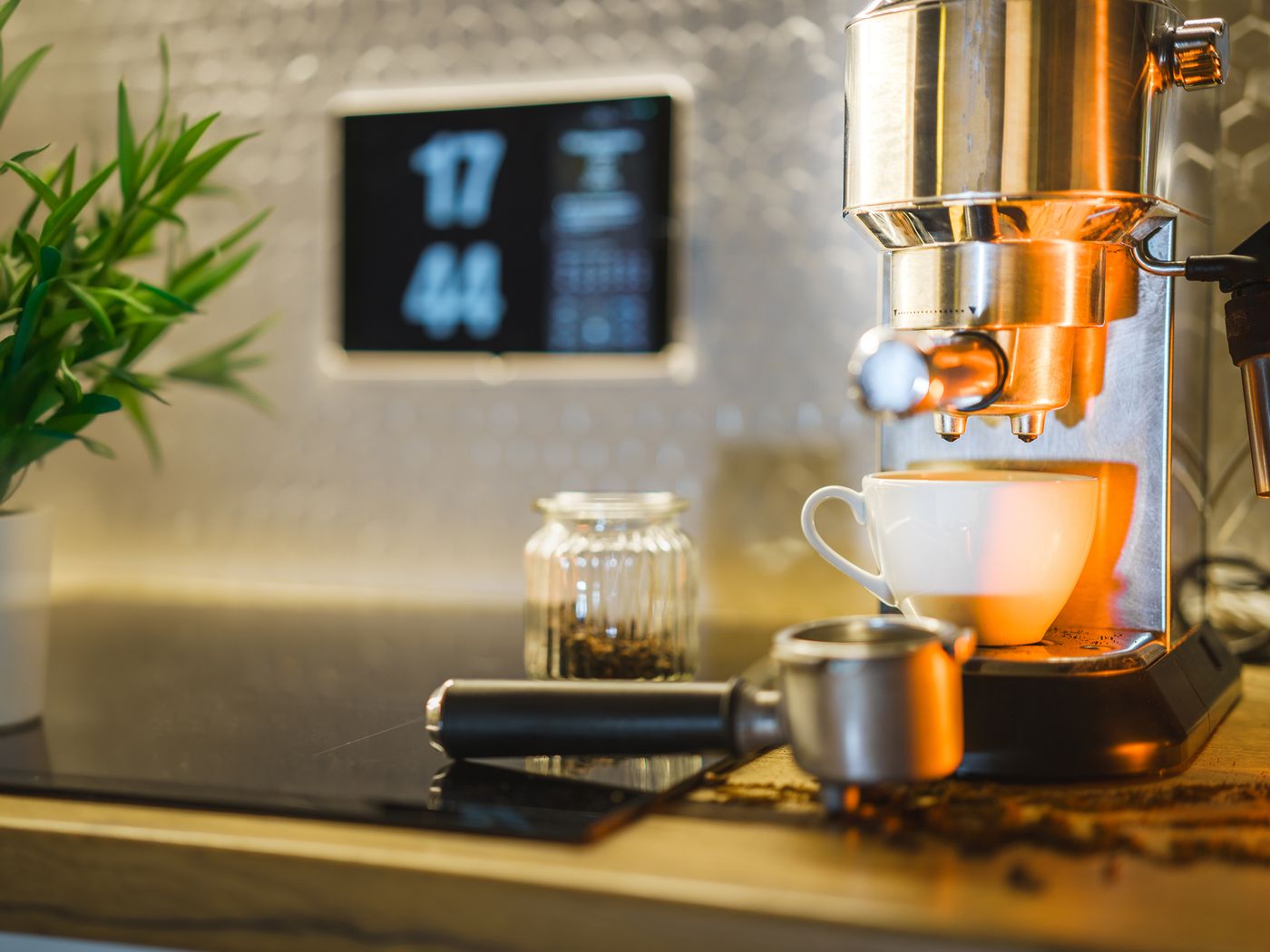 A cup positioned beneath a home coffee machine
