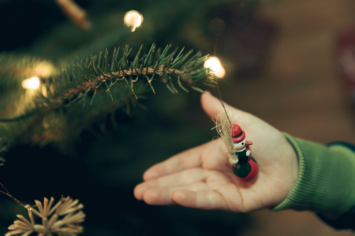 A small hanging ornament supported in an open hand