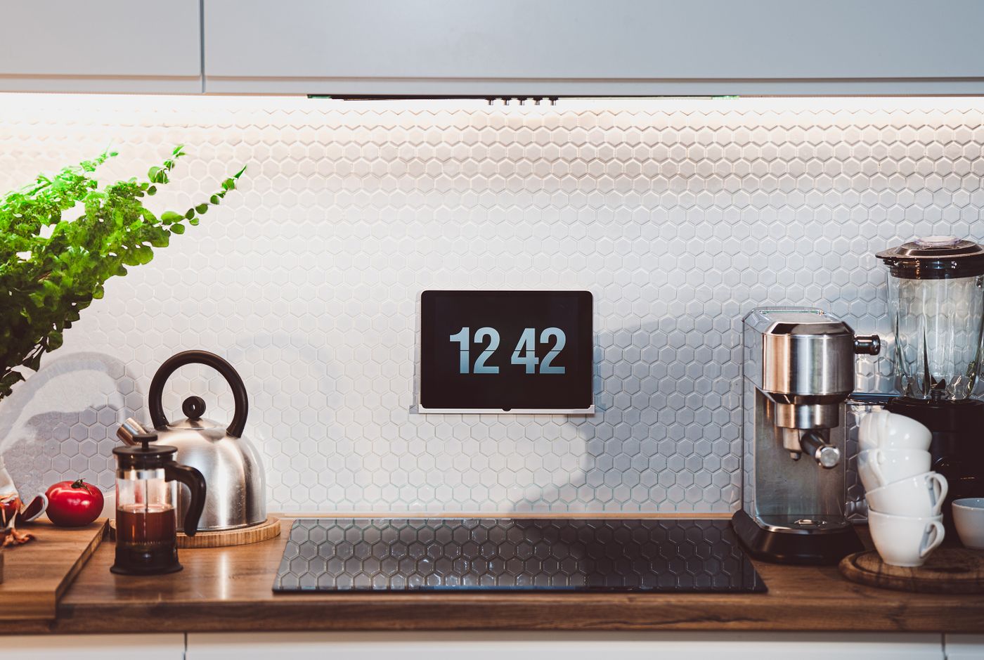 A kitchen counter with a kettle and coffee accessories