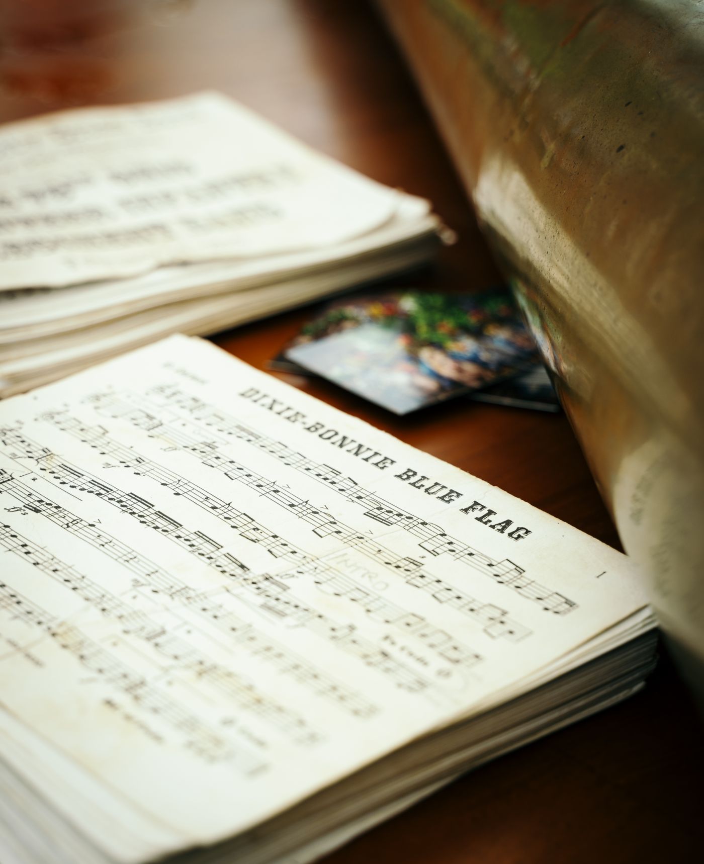 Several music books and loose scores stacked together