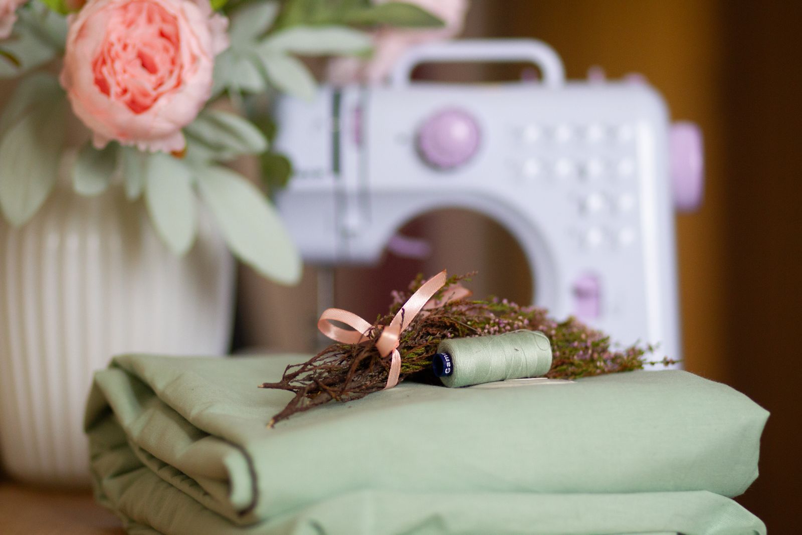 Folded fabric and thread in front of a sewing machine