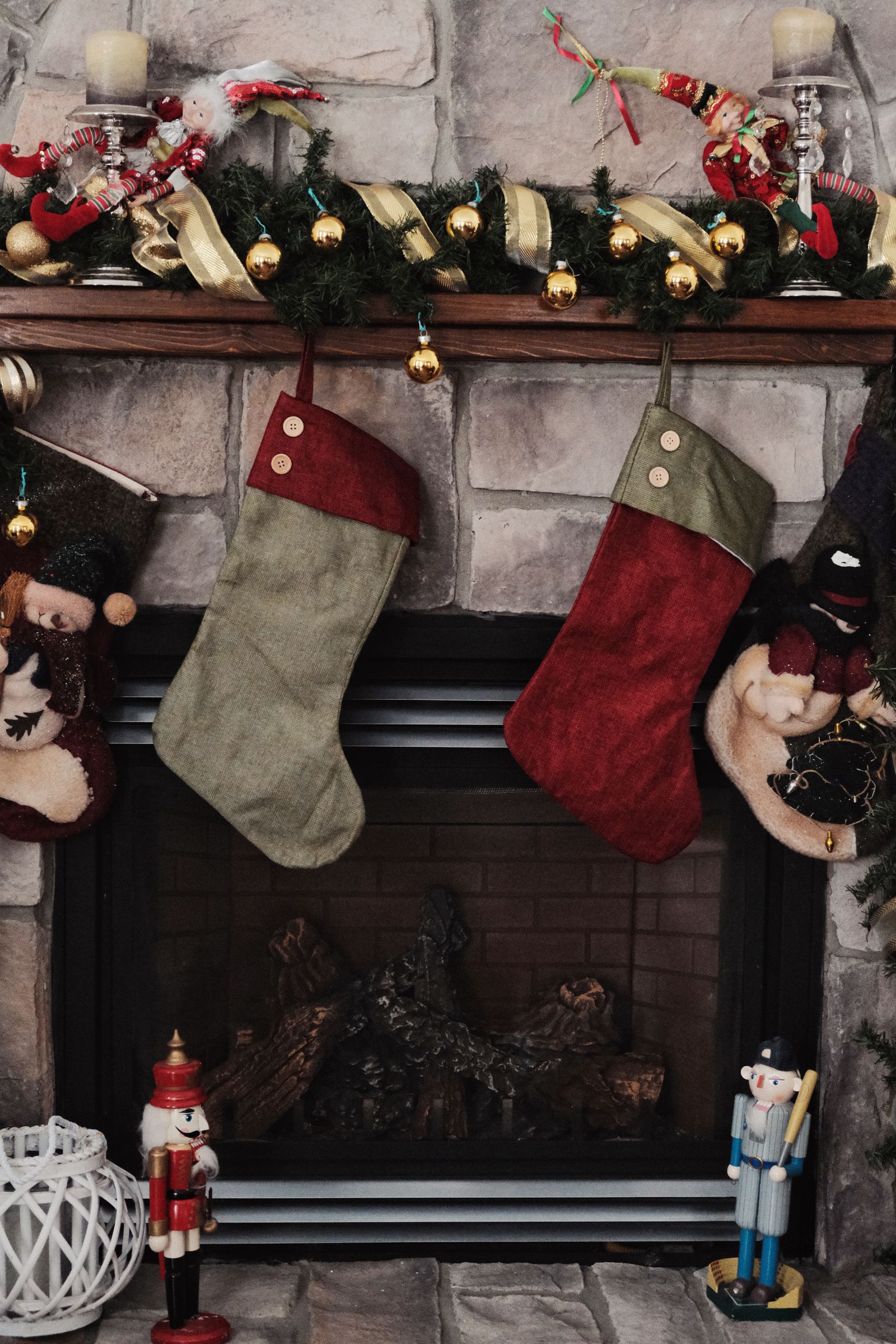 Christmas stockings arranged along a decorated fireplace mantel