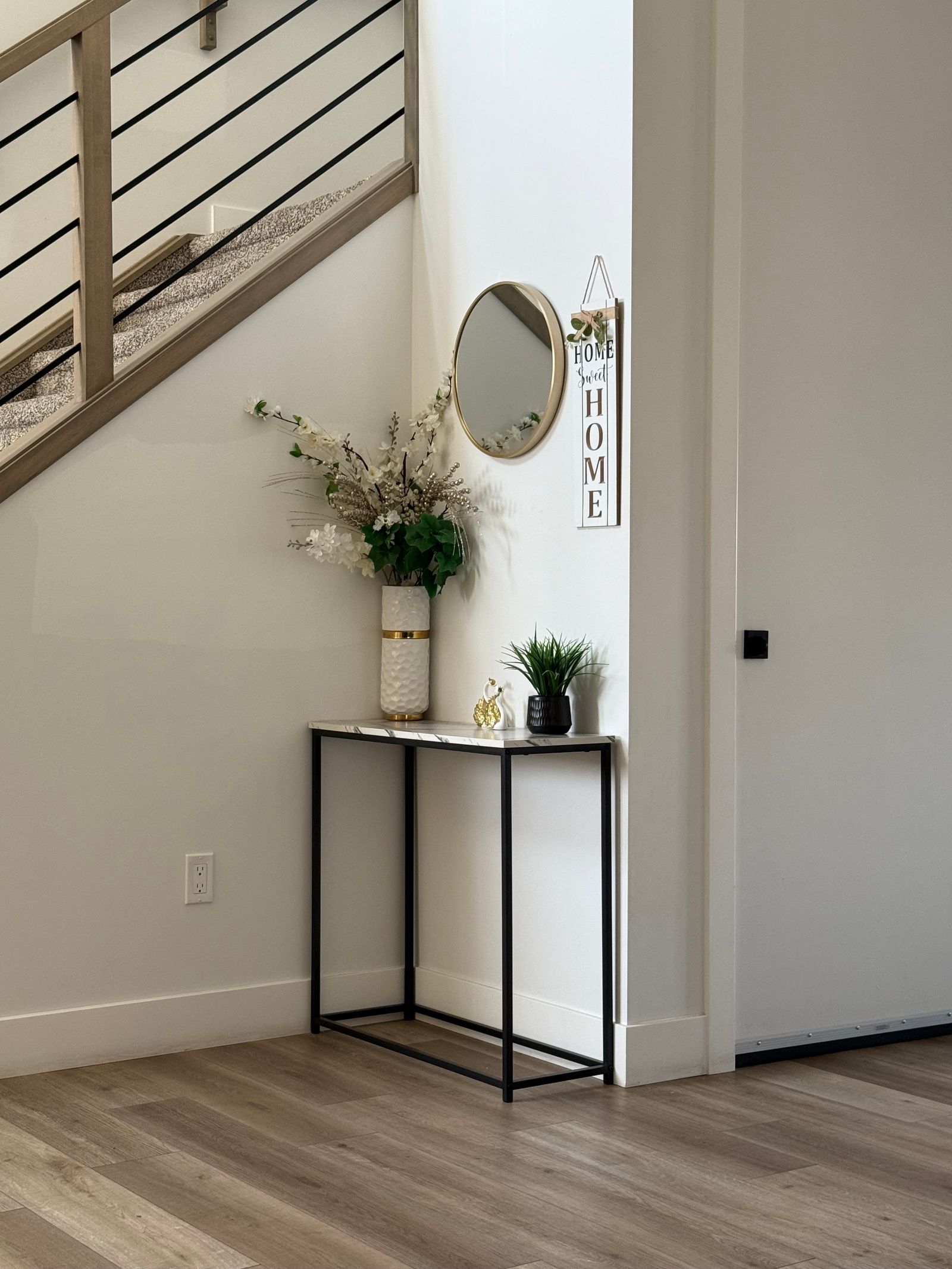 A narrow entryway console with decorative objects
