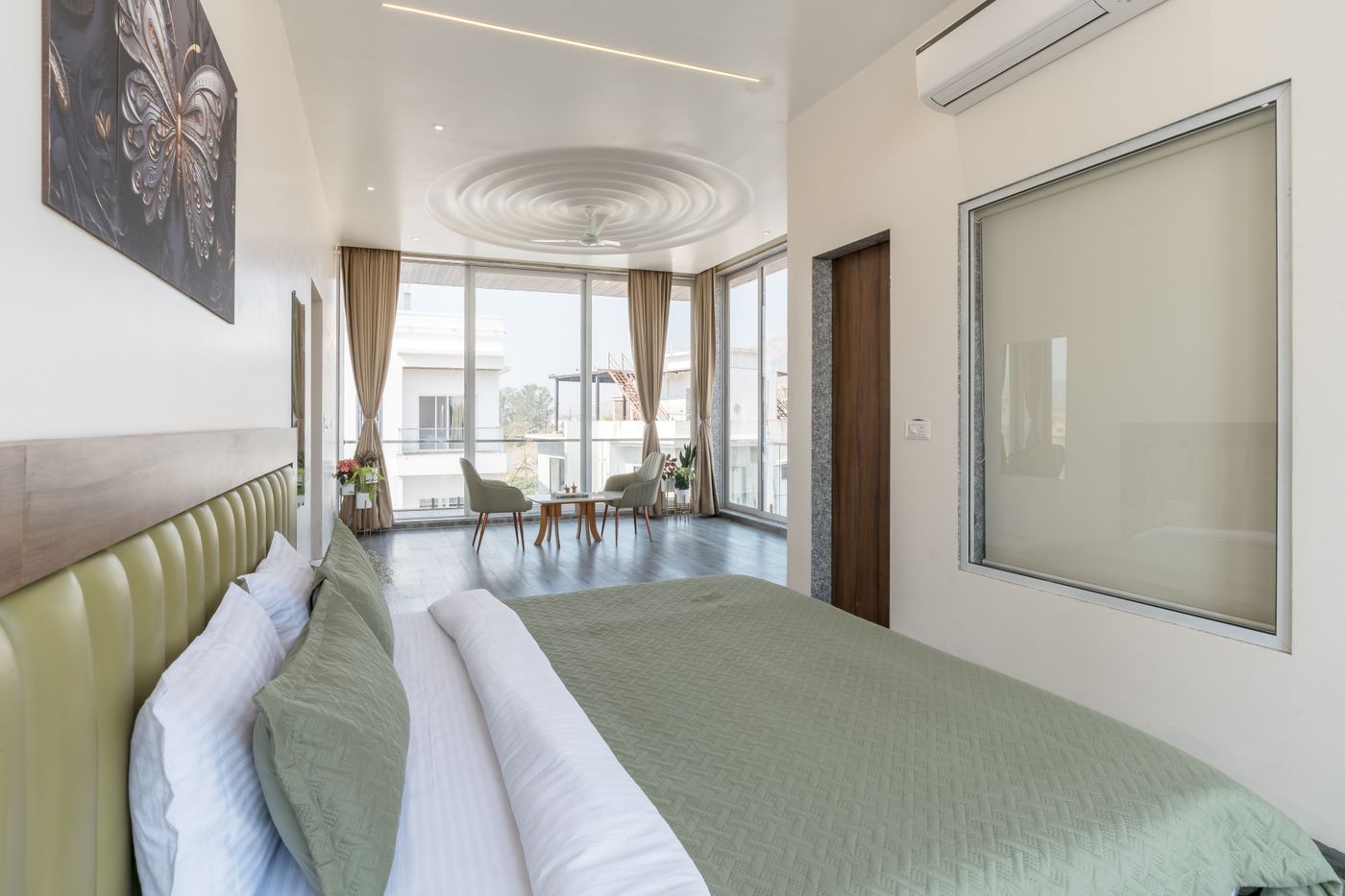 Pale green headboard and textiles in a bedroom