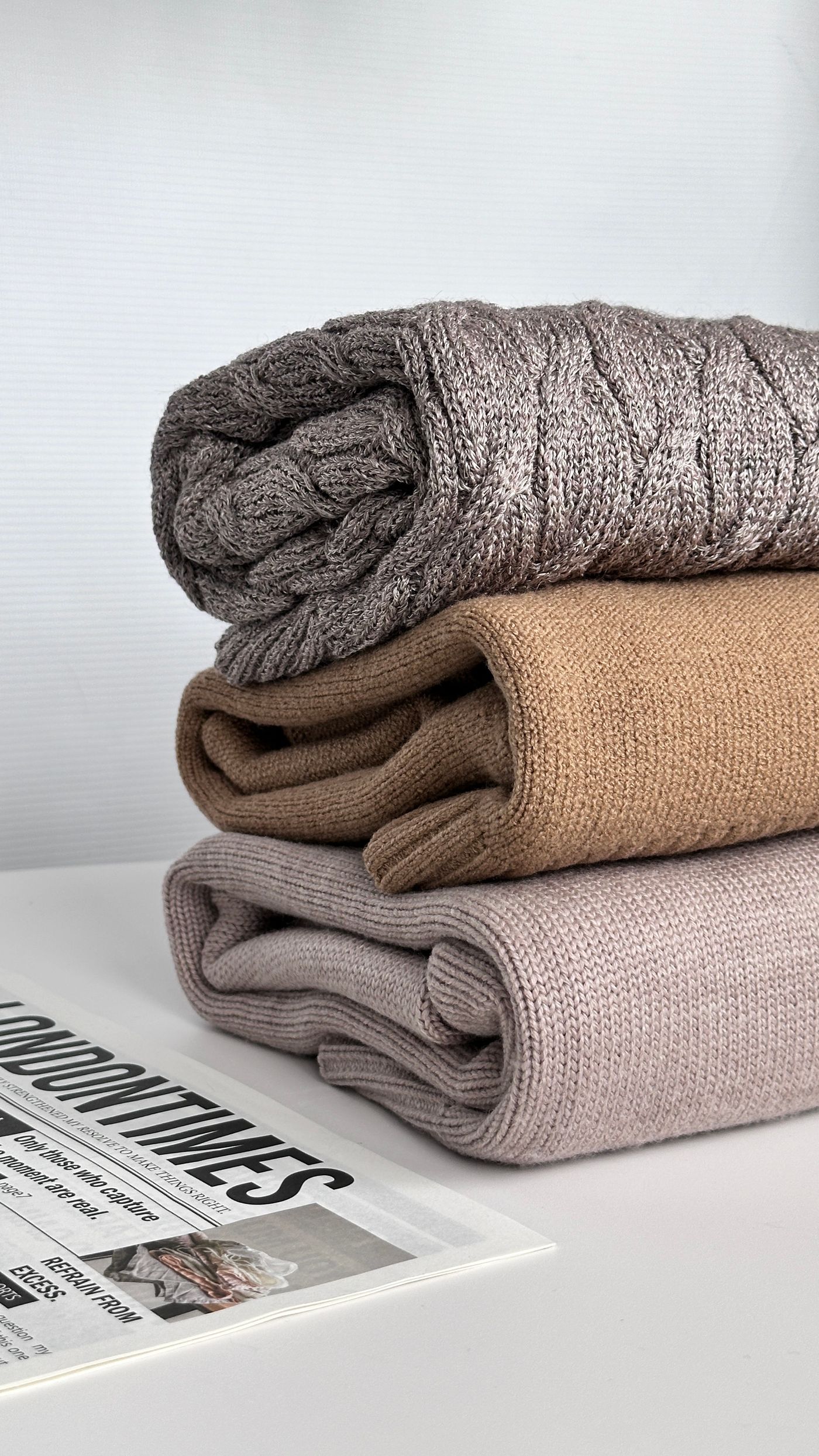 Folded knitted textiles in neutral and muted colors