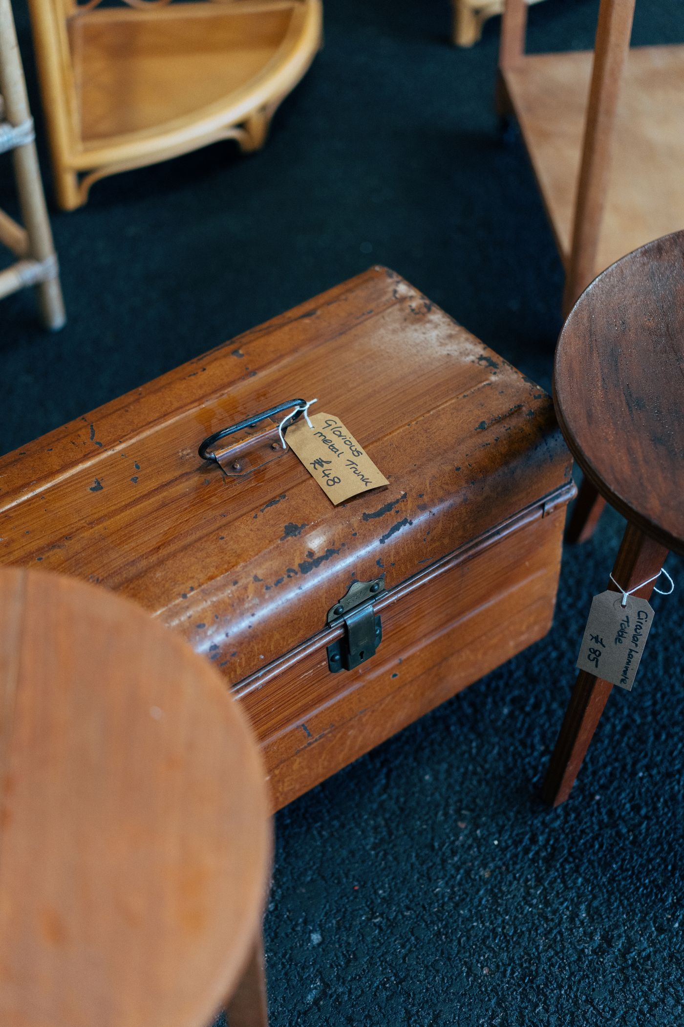 A wooden secondhand trunk with a hanging label