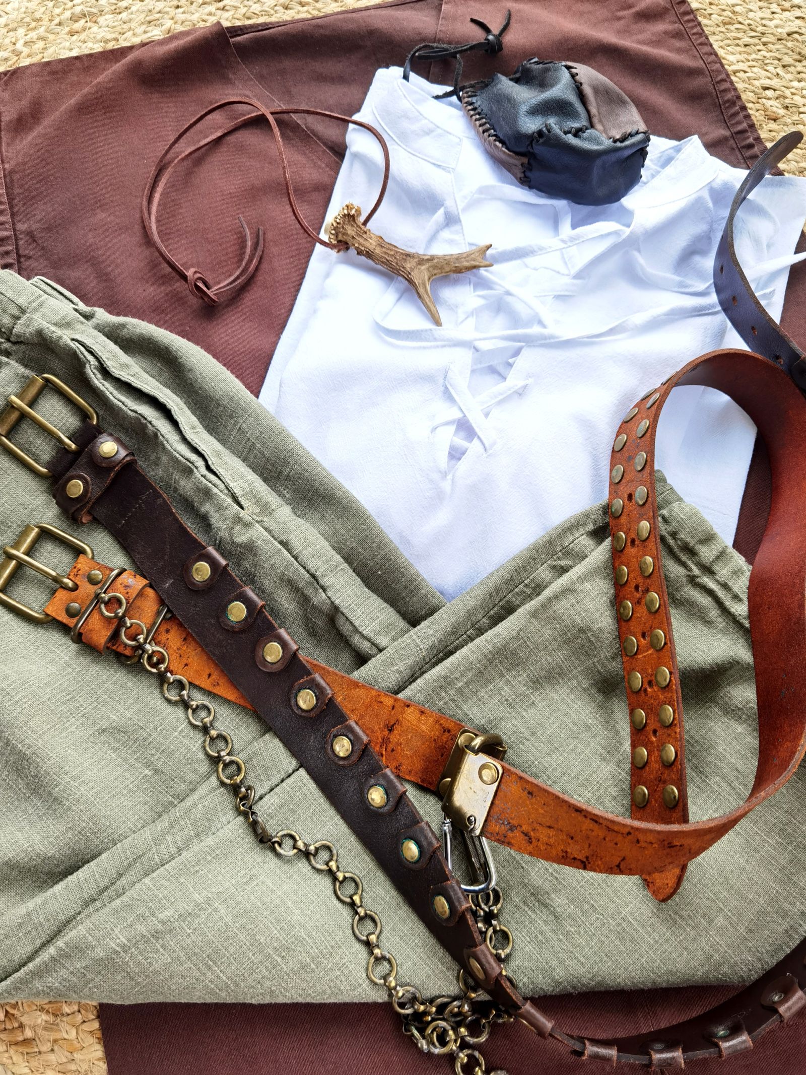 Belts and accessories arranged over folded clothing