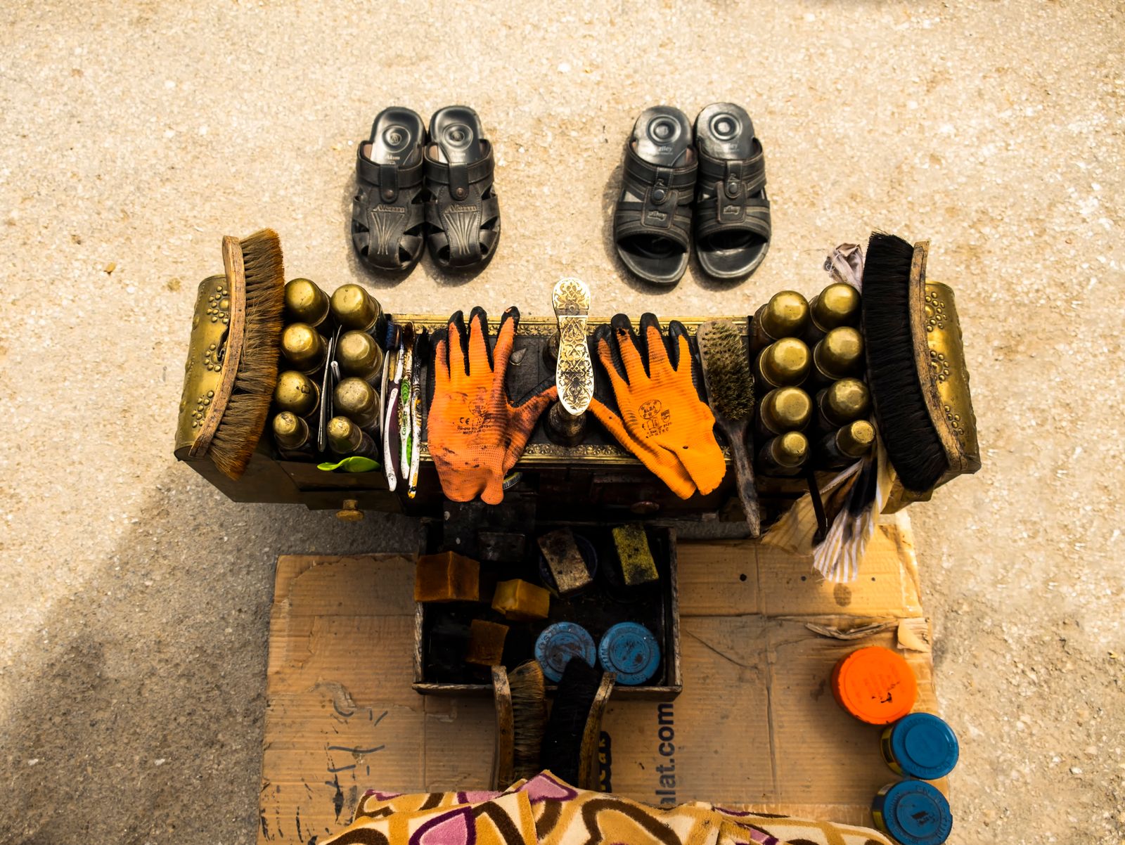 Brushes, containers, and gloves at a shoe-shine station