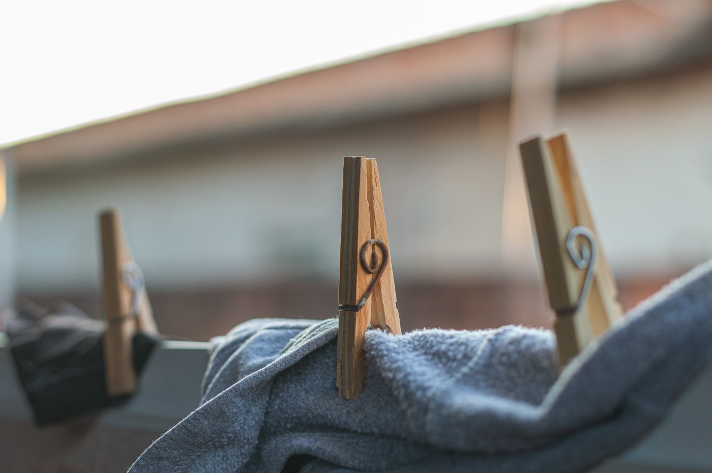 Wooden clothespins holding fabric on a line