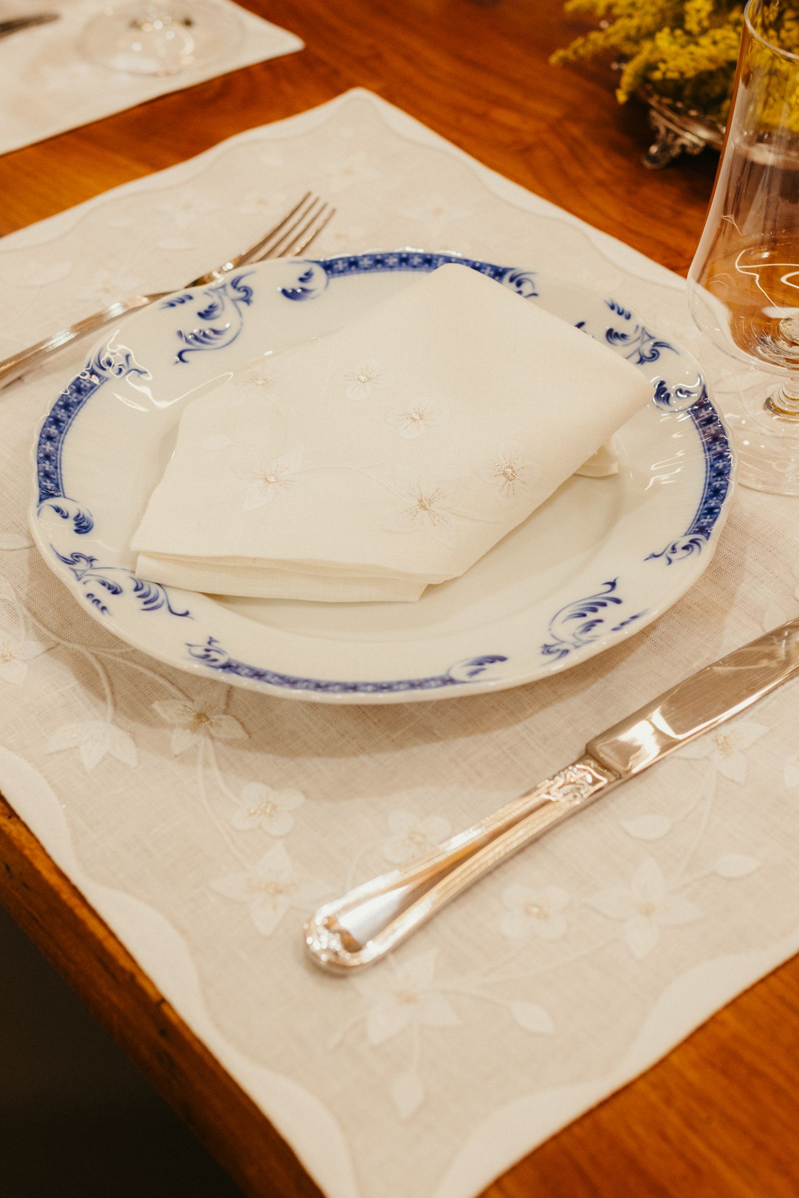 A floral plate and napkin on a pale table mat