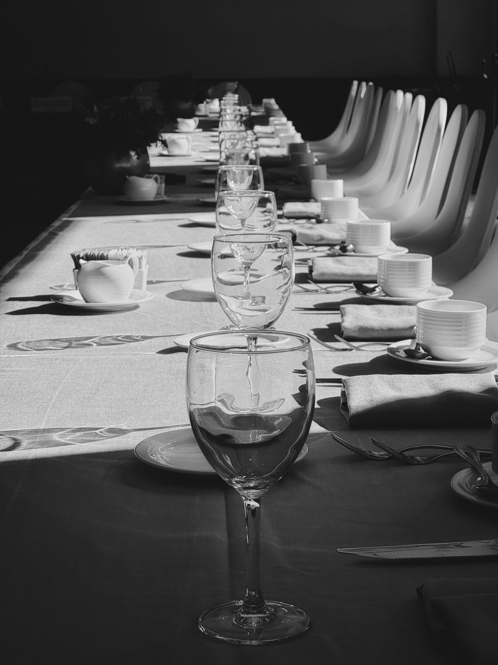Black-and-white photograph of a formal dining-table setting