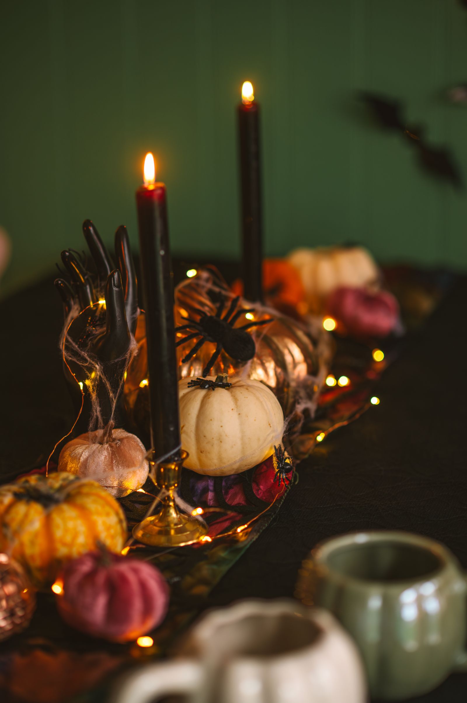 A Halloween table setting with pumpkins and candles
