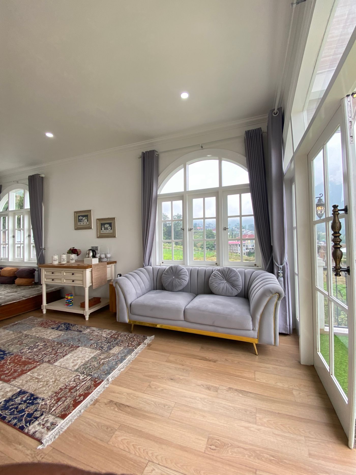 A sitting room with distinct rug and bare-floor areas