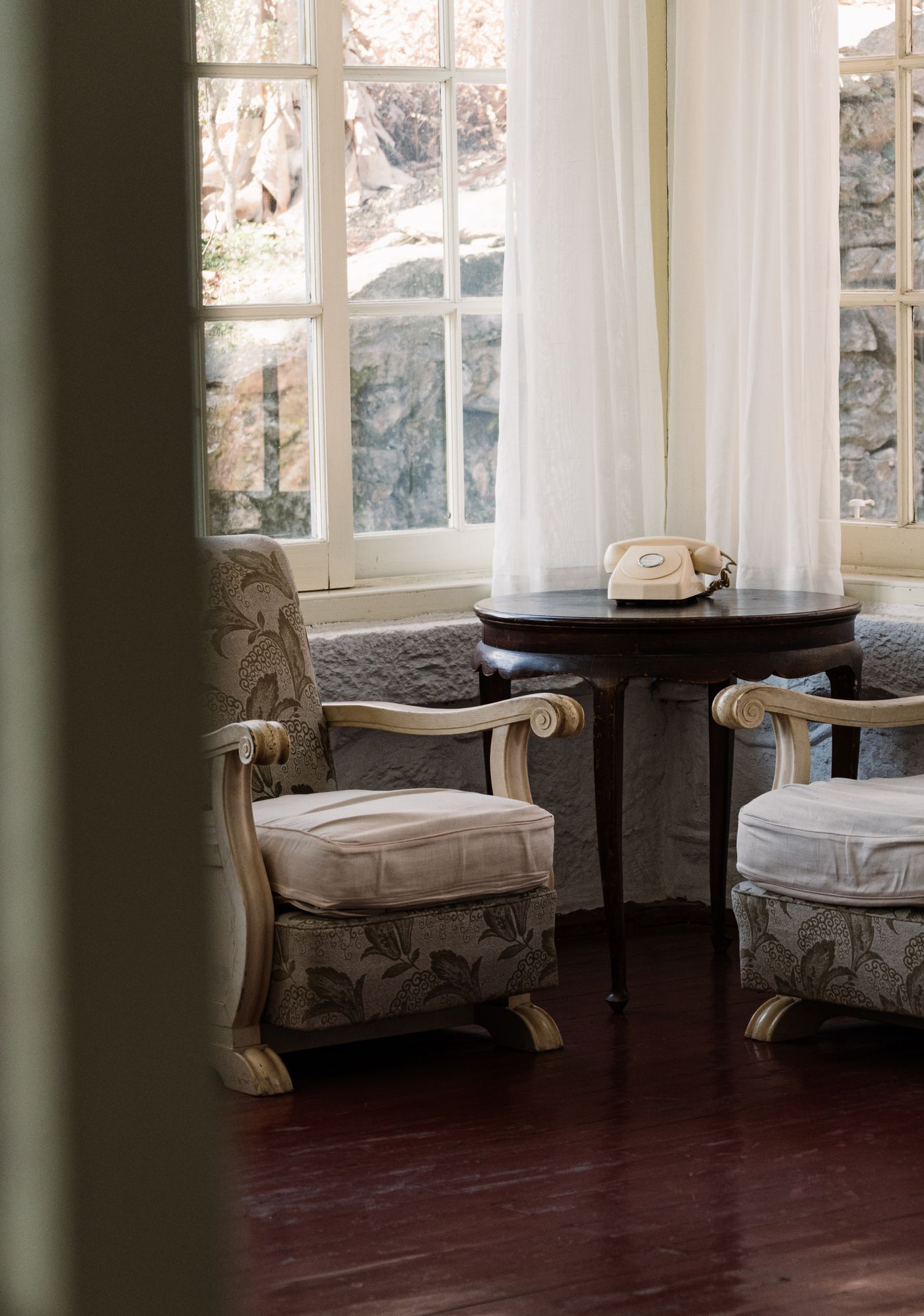 Two chairs beside a small table in a compact corner