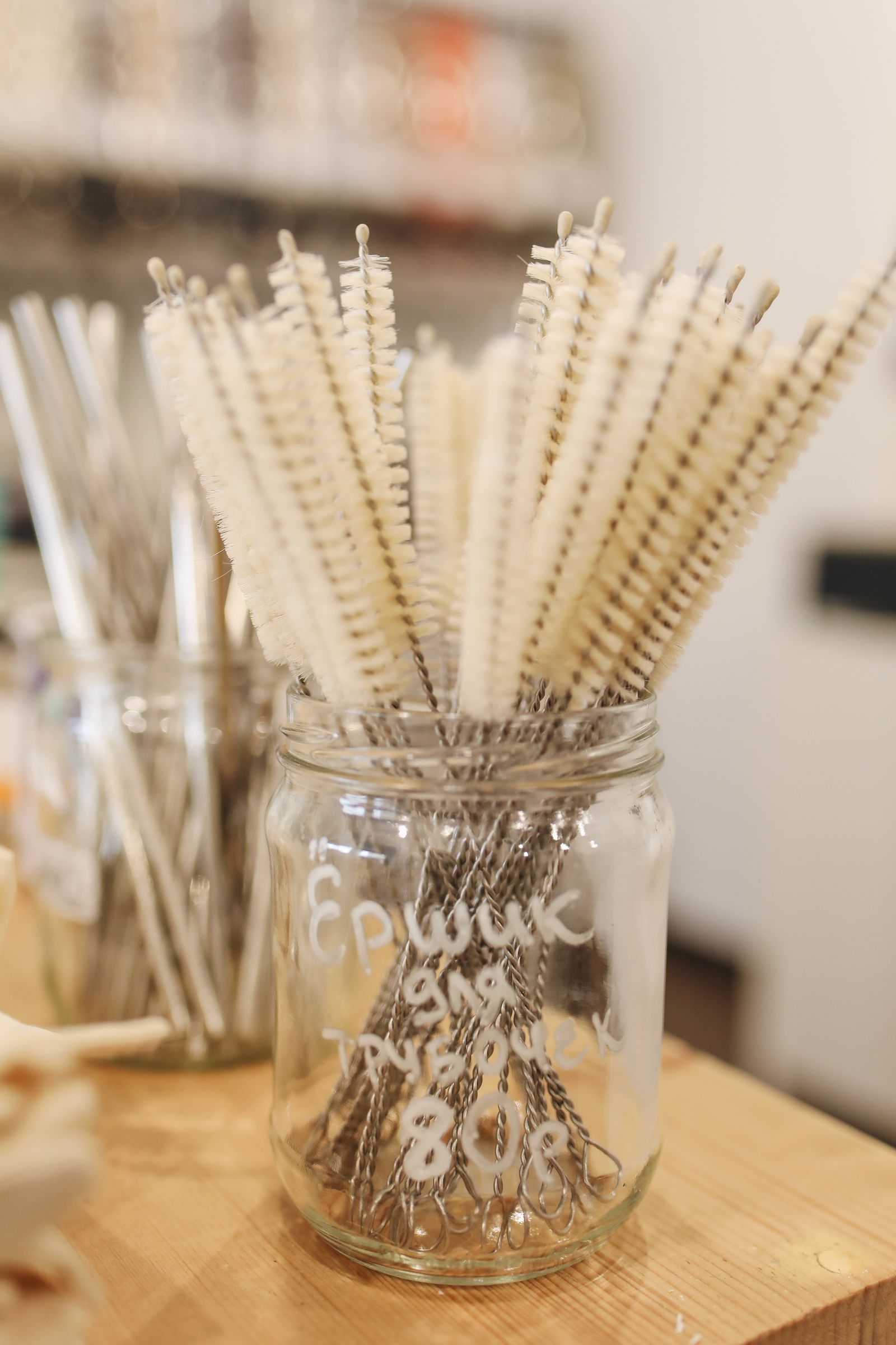 Narrow cleaning brushes standing in a glass jar