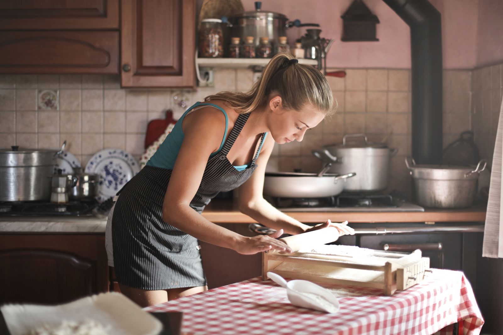 A person preparing dough in a kitchen