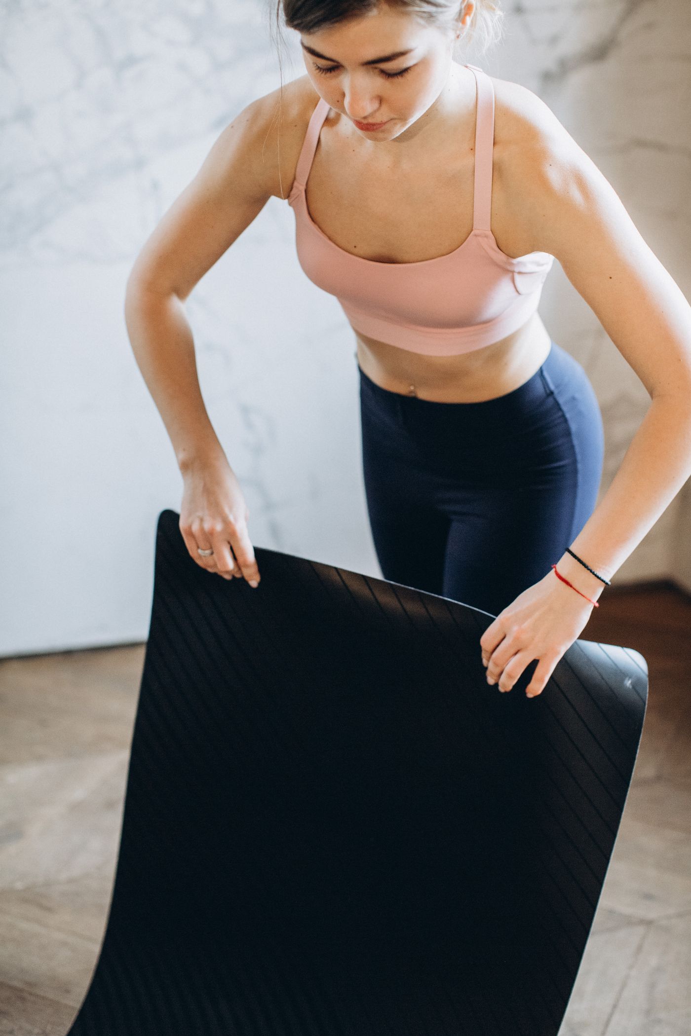 Person preparing to roll a mat away