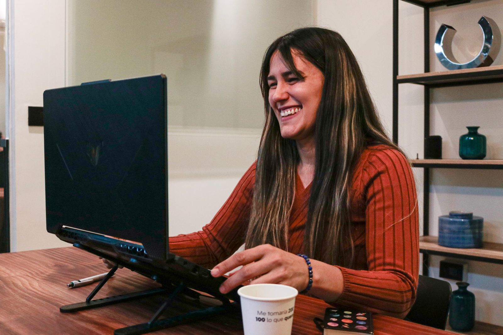 A person participating in a video call at a home-office desk